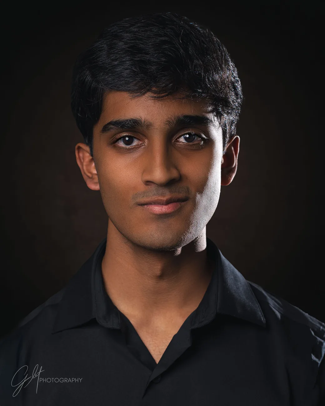 A young actor's commercial headshot in a dark shirt